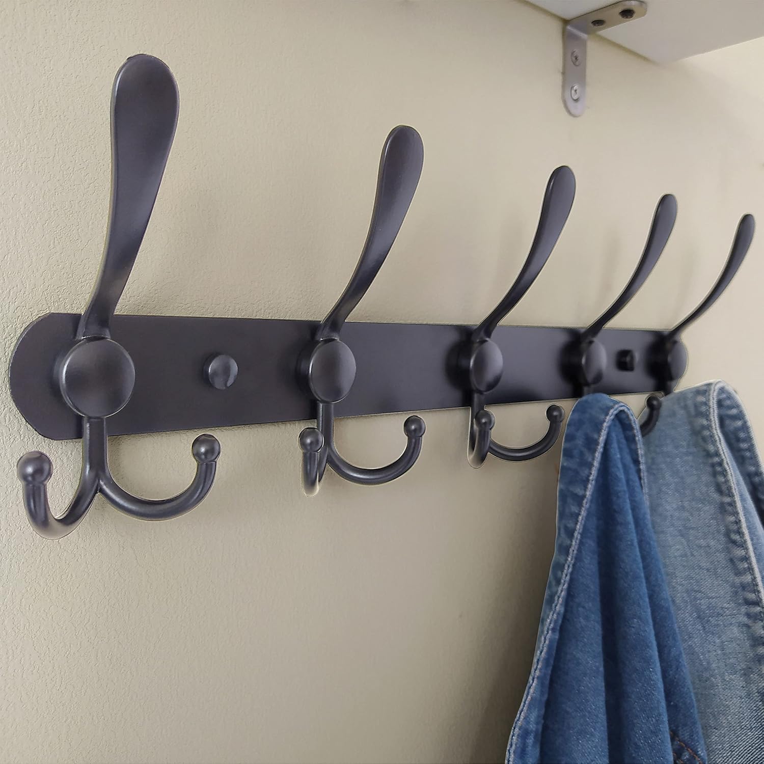 Wall-mounted coat rack—5 three-prong hooks.